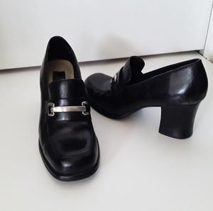 Loafer style pumps with a silver buckle hardware detail